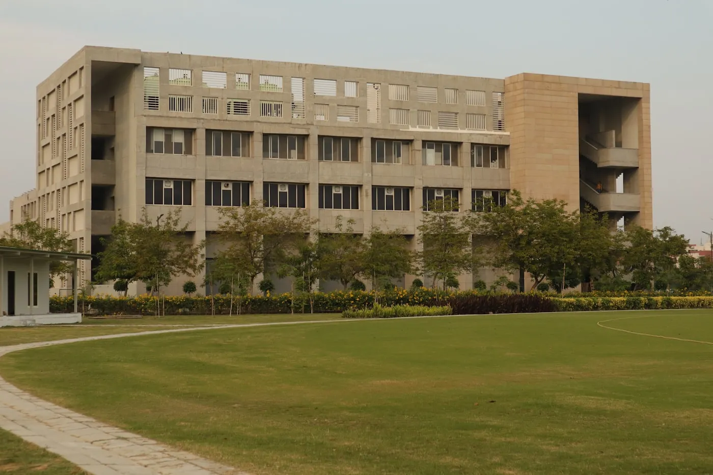 A large modern university building set in green grounds in India