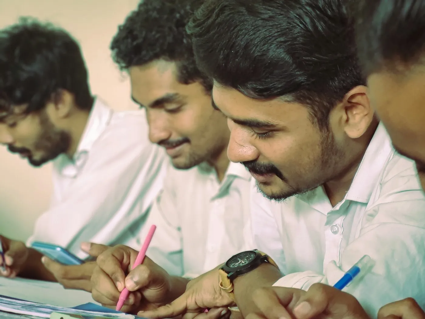 A researcher in a white coat working at a laboratory bench in India